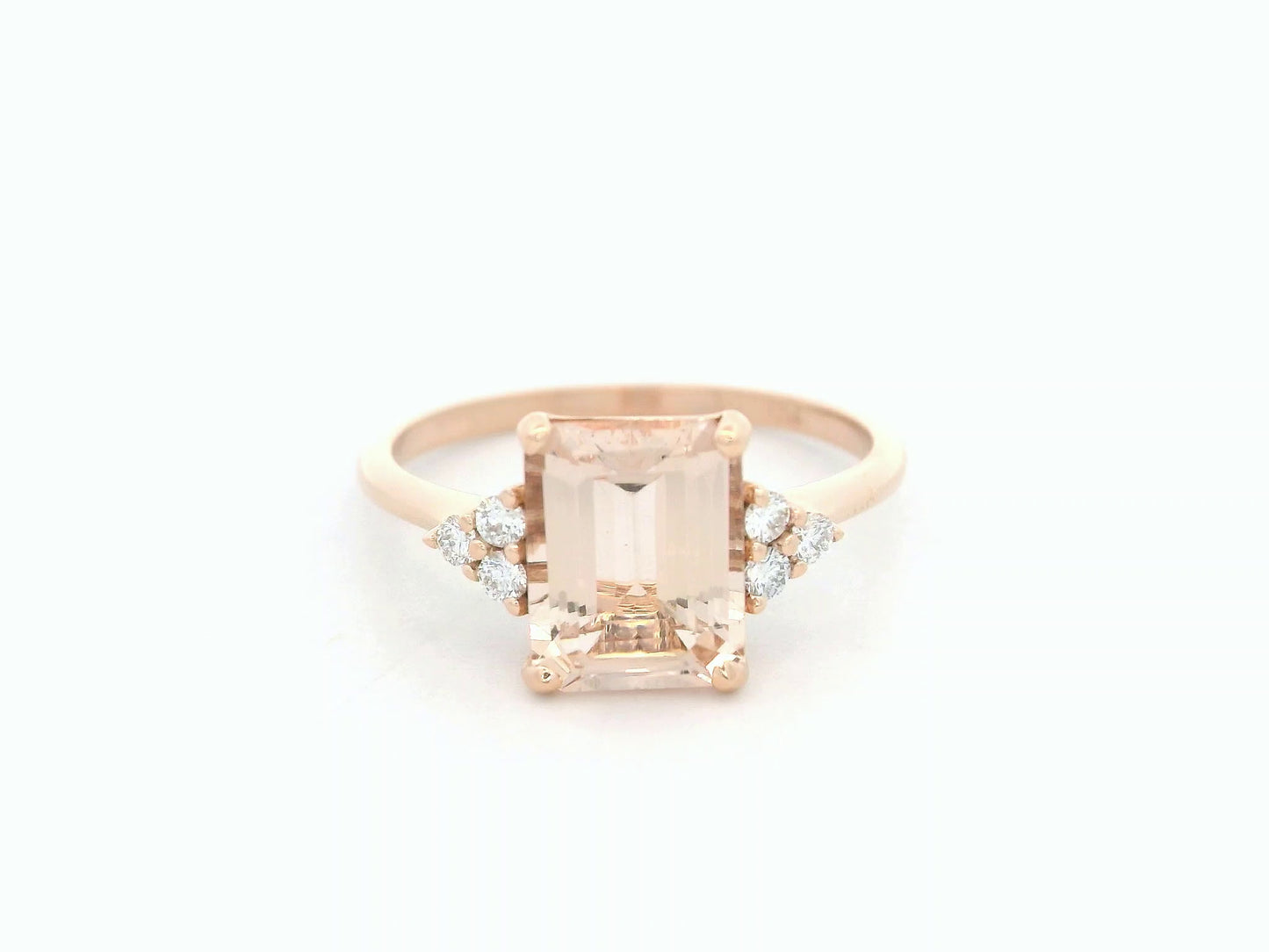 18K rose gold ring featuring a 1.80ct emerald-cut Morganite with diamond clusters on each side.