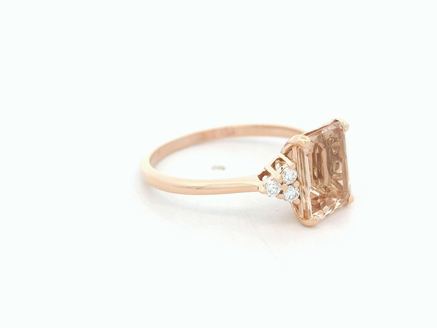 18K rose gold ring featuring a 1.80ct emerald-cut Morganite with diamond clusters on each side.