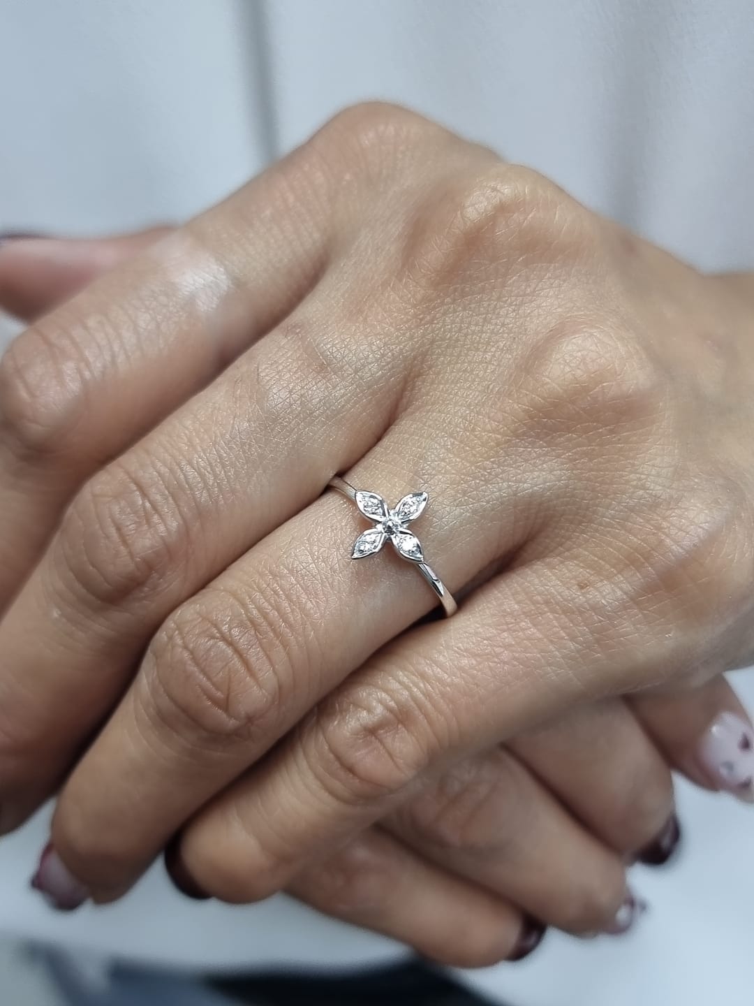 18k gold ring featuring a floral motif with four marquise-shaped diamonds forming a cross, set on a slim minimalist band for modern elegance
