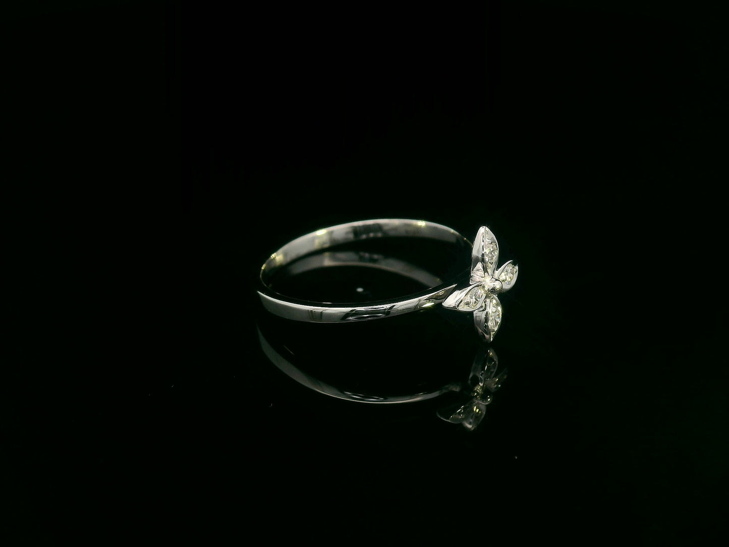 18k gold ring featuring a floral motif with four marquise-shaped diamonds forming a cross, set on a slim minimalist band for modern elegance