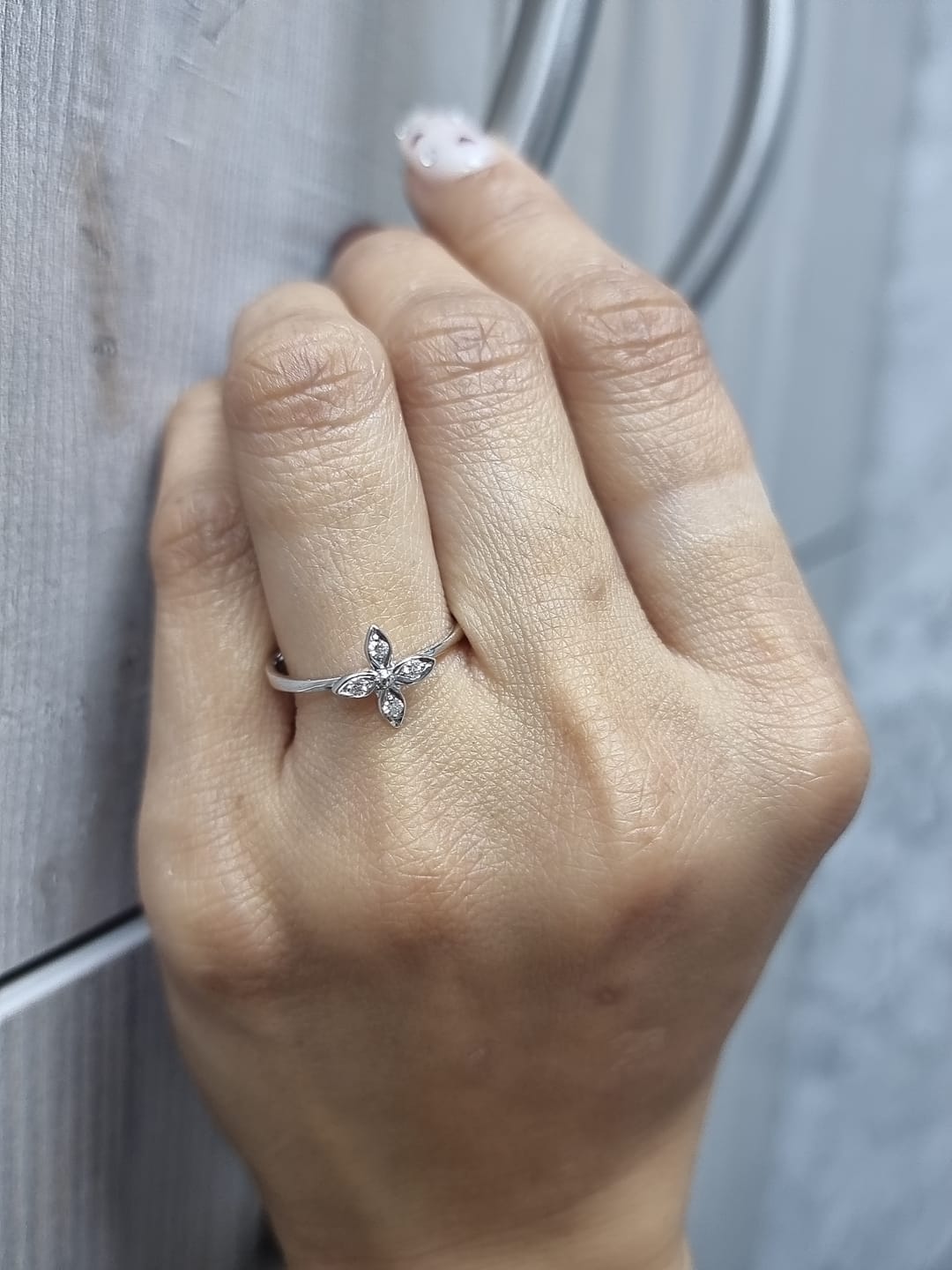 18k gold ring featuring a floral motif with four marquise-shaped diamonds forming a cross, set on a slim minimalist band for modern elegance