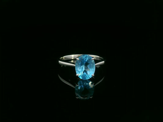 18K white gold ring featuring a 2.24ct oval-cut Blue Topaz prong-set centerpiece.