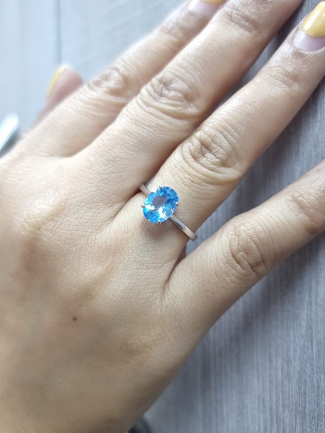 18K white gold ring featuring a 2.24ct oval-cut Blue Topaz prong-set centerpiece.