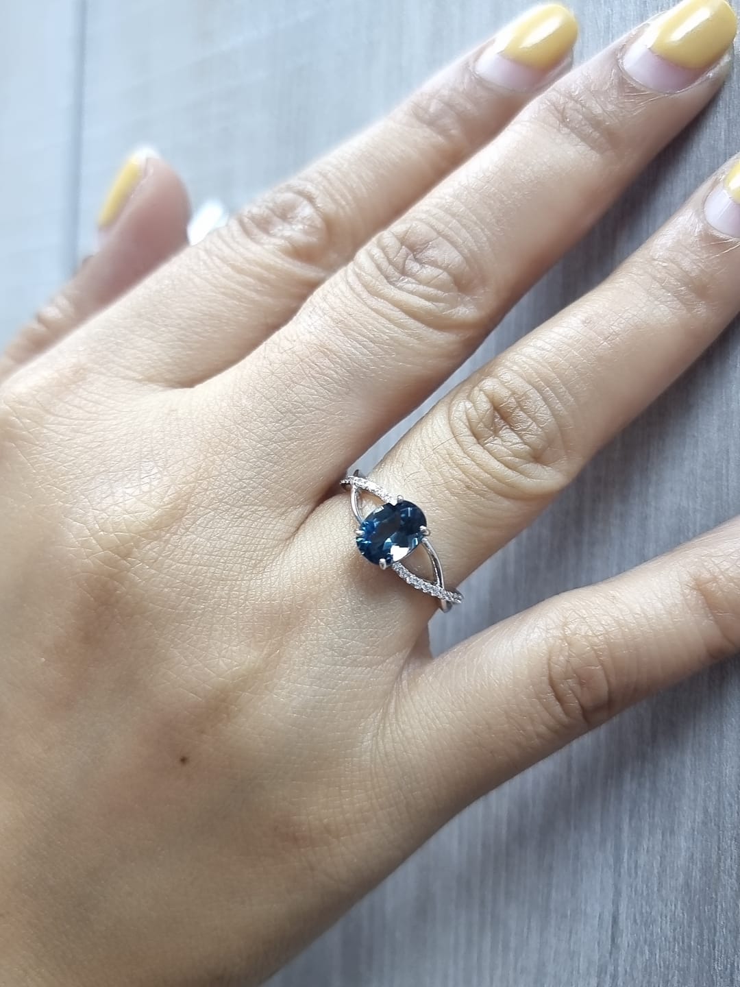 18K white gold ring featuring a 1.58ct London Blue Topaz with 0.11ct diamonds set along a twisted split-shank band.