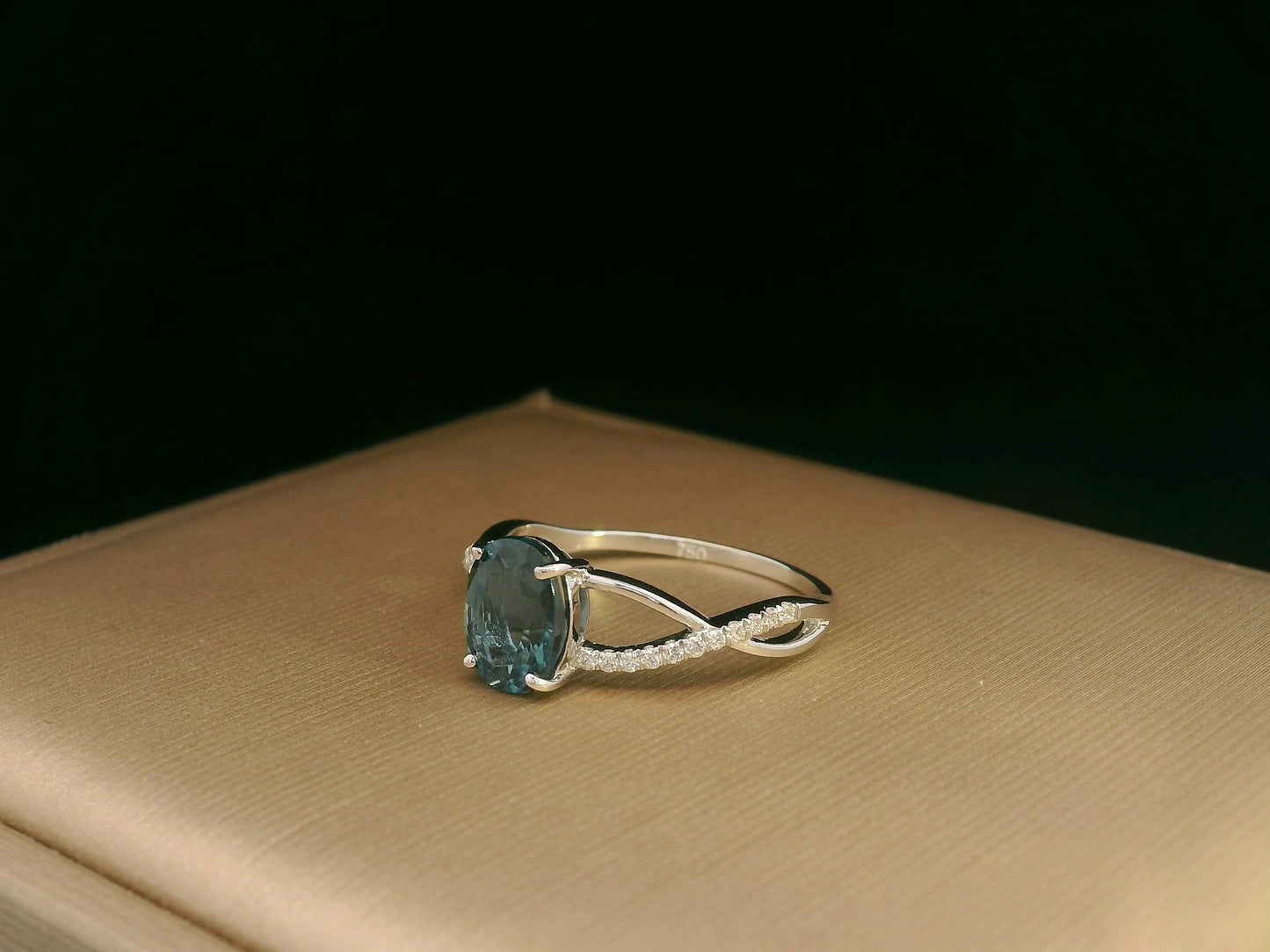 18K white gold ring featuring a 1.58ct London Blue Topaz with 0.11ct diamonds set along a twisted split-shank band.