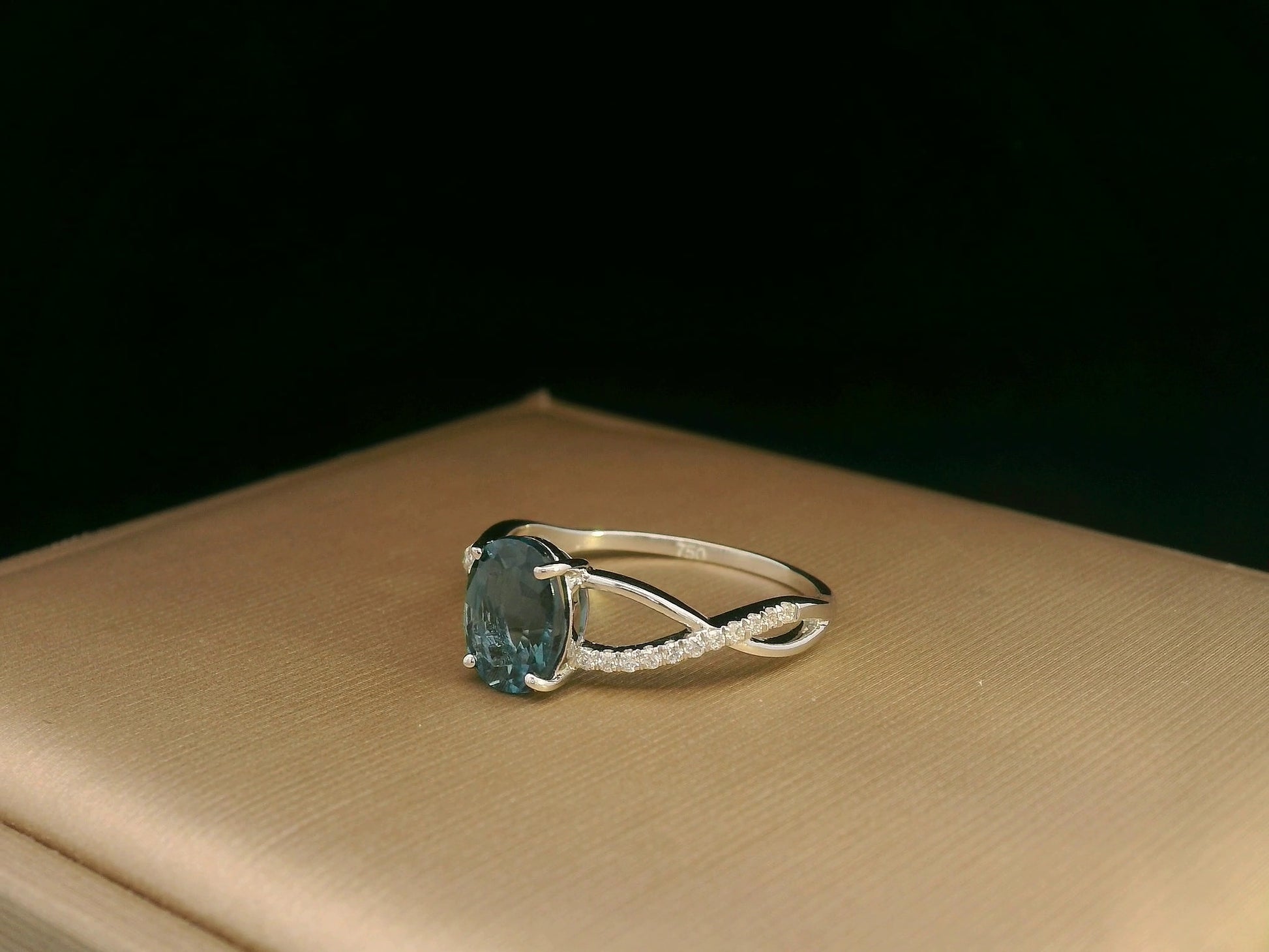 18K white gold ring featuring a 1.58ct London Blue Topaz with 0.11ct diamonds set along a twisted split-shank band.