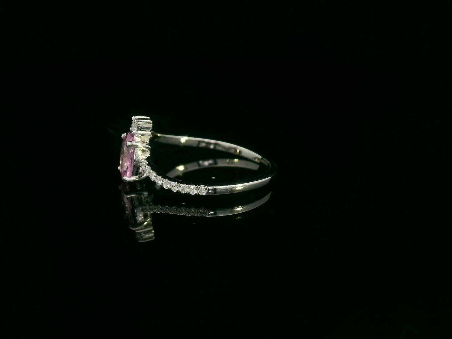 18K white gold ring featuring a 0.75ct oval Pink Sapphire with 0.12ct diamonds on an asymmetric split band.