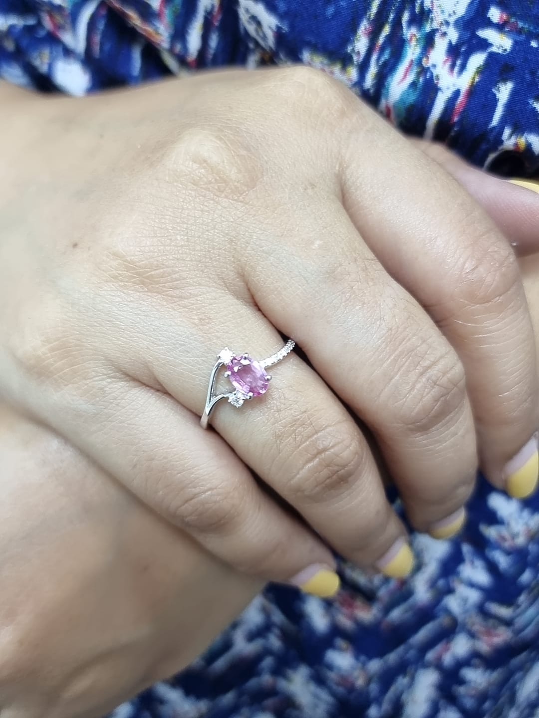 18K white gold ring featuring a 0.75ct oval Pink Sapphire with 0.12ct diamonds on an asymmetric split band.