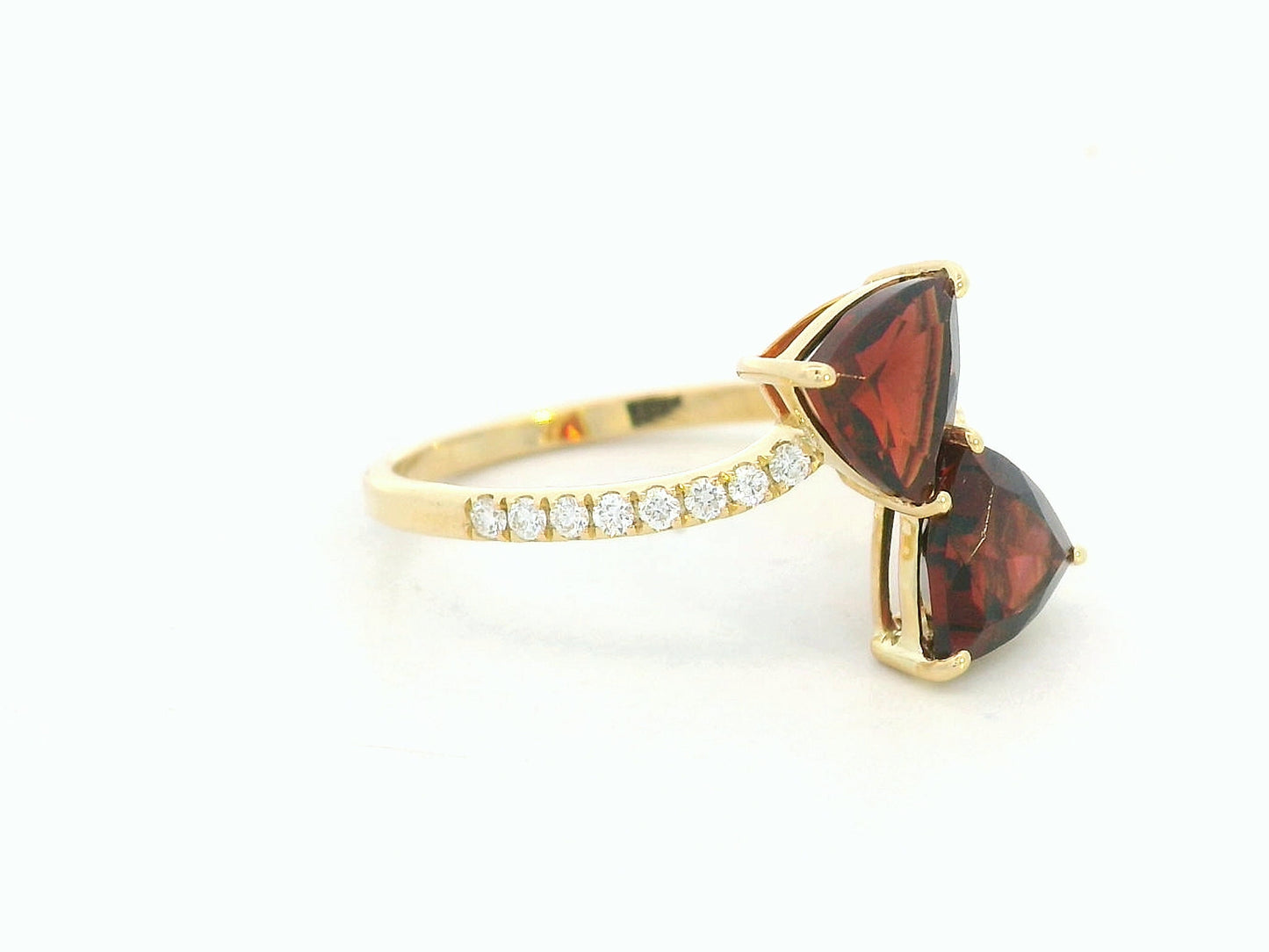 18K yellow gold open bypass ring with trillion-cut garnets and pavé diamonds, modern luxury design