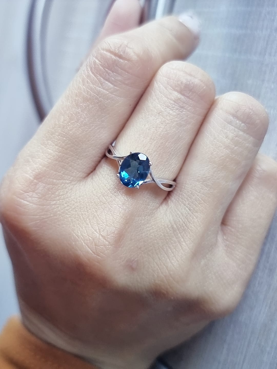 18K white gold bypass ring with 1.86 carat oval London Blue Topaz, elegant statement design