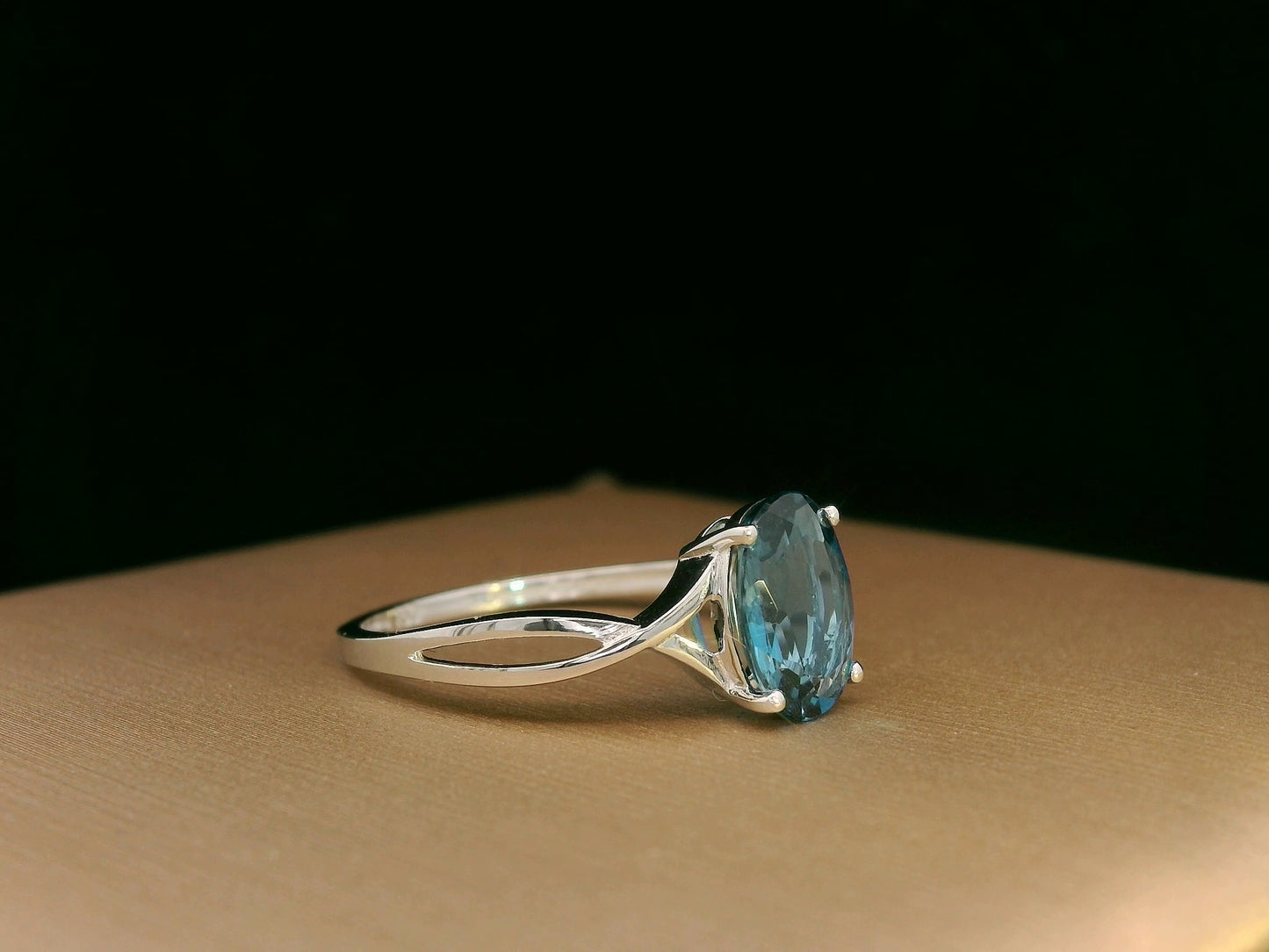 18K white gold bypass ring with 1.86 carat oval London Blue Topaz, elegant statement design