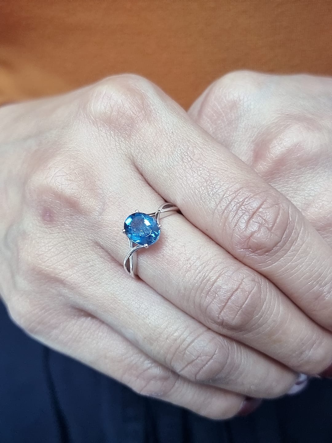 18K white gold bypass ring with 1.86 carat oval London Blue Topaz, elegant statement design