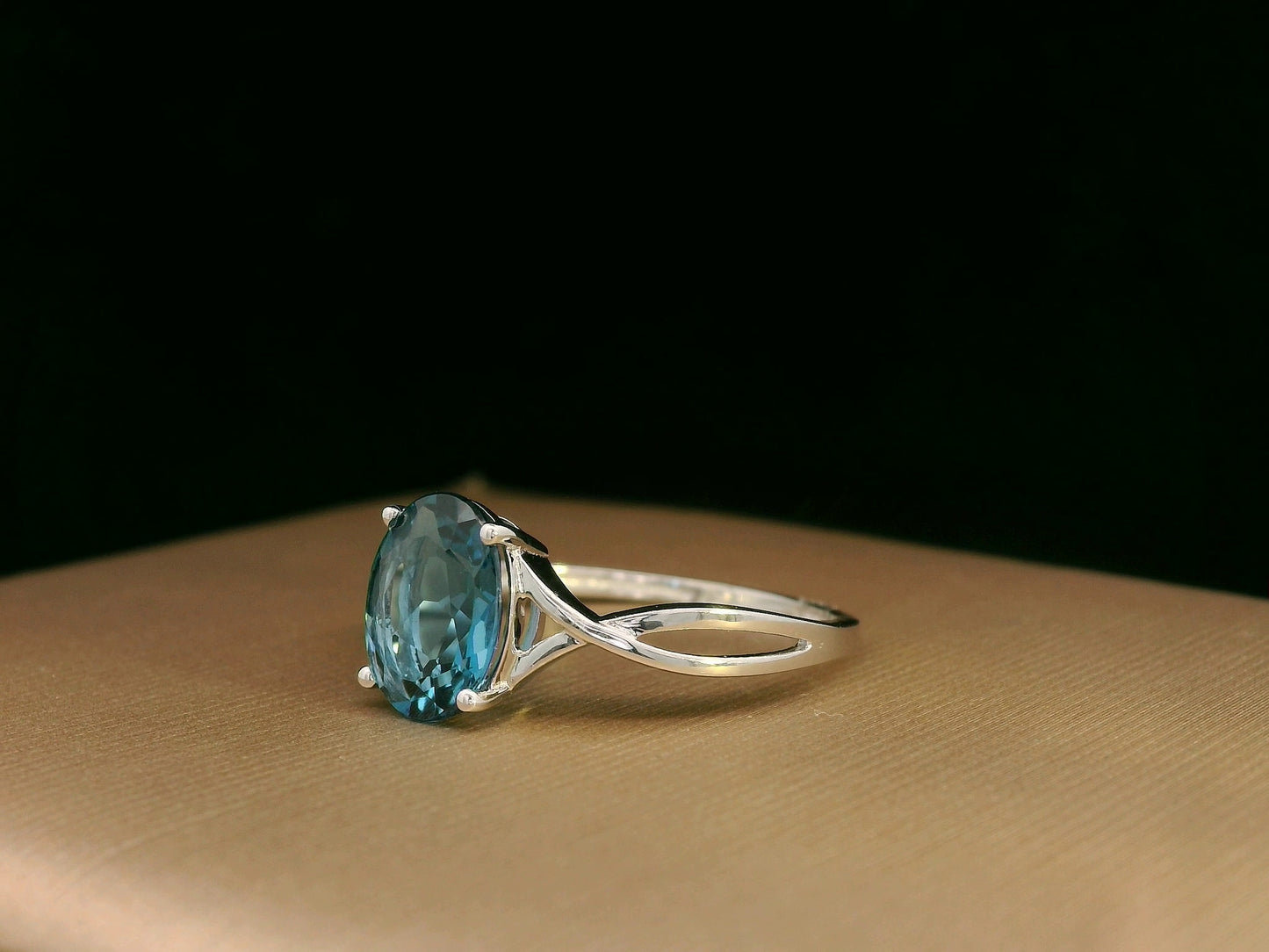 18K white gold bypass ring with 1.86 carat oval London Blue Topaz, elegant statement design