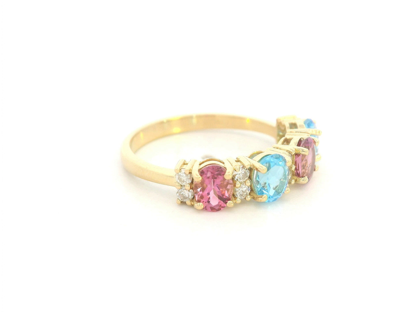 18K yellow gold band with alternating oval pink and blue sapphires and round diamond accents
