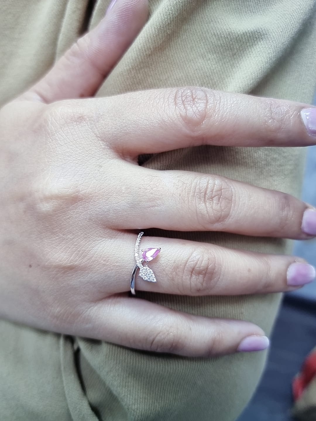 18K white gold bypass ring featuring 0.37ct pear pink sapphire and 0.15ct diamonds in a modern pear motif design.