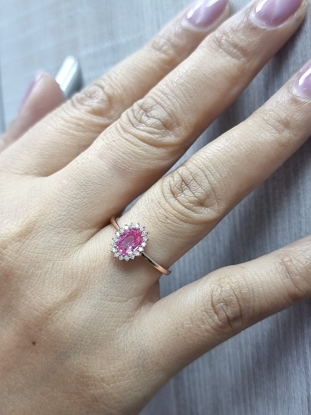 18K rose gold oval pink sapphire and diamond halo ring – fine jewelry by Emirates Diamonds.