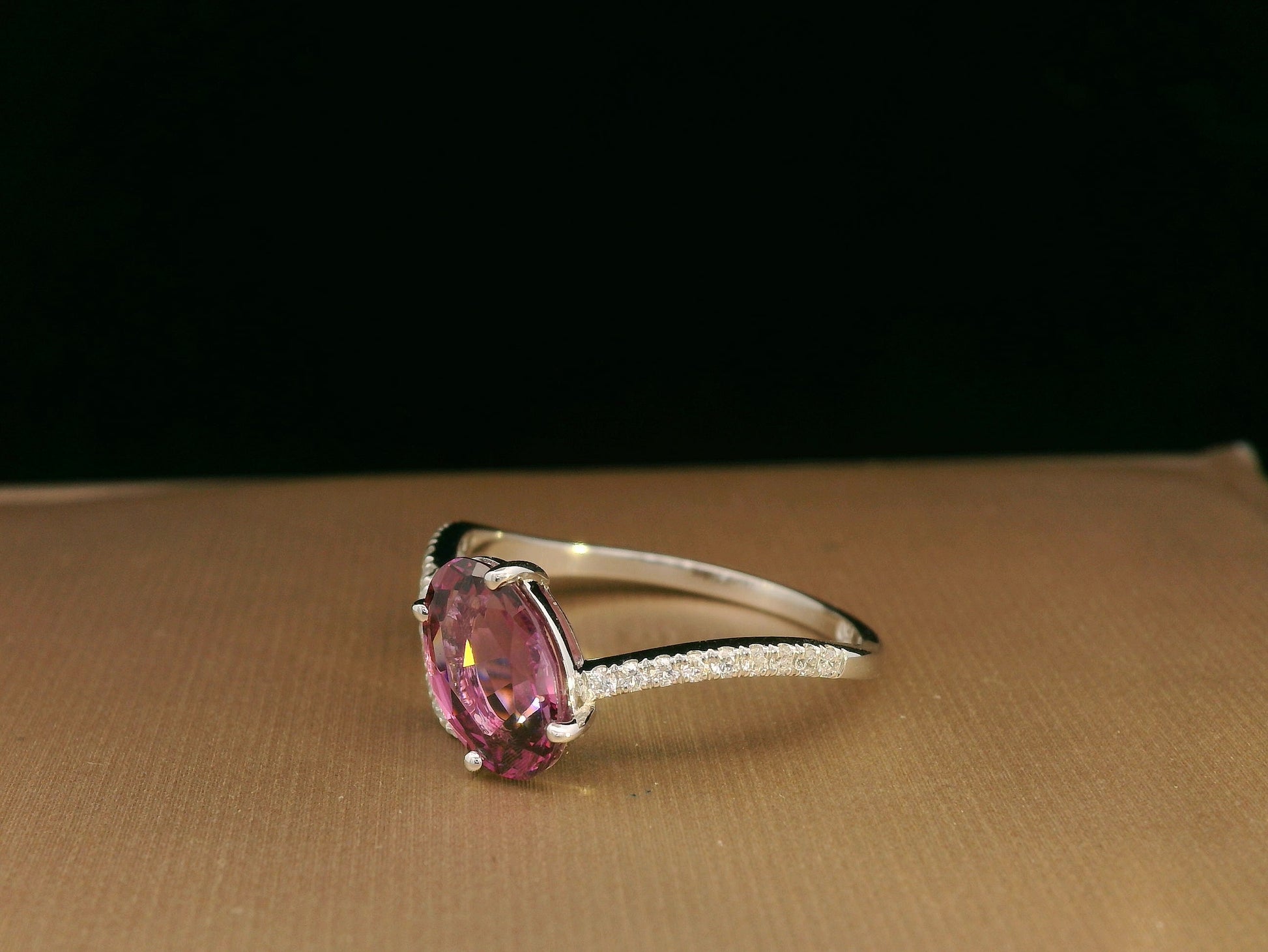 18K white gold Rhodolite garnet and diamond crossover ring with oval-cut center stone