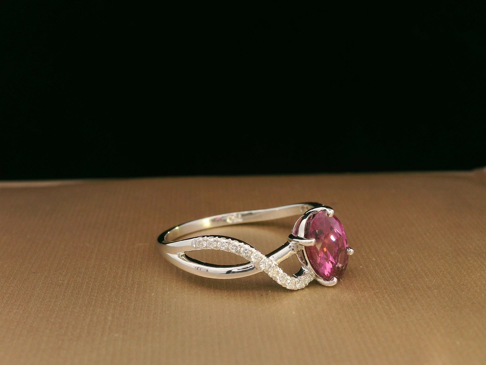 18K white gold Rhodolite garnet and diamond crossover ring with oval-cut center stone