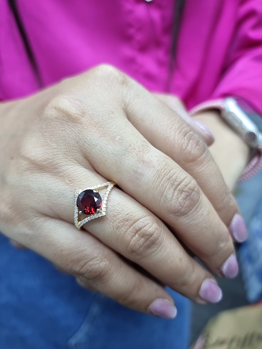 Round garnet split-shank ring with diamond accents in 18K yellow gold