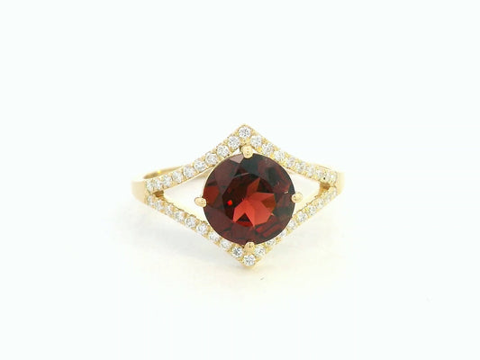 Round garnet split-shank ring with diamond accents in 18K yellow gold
