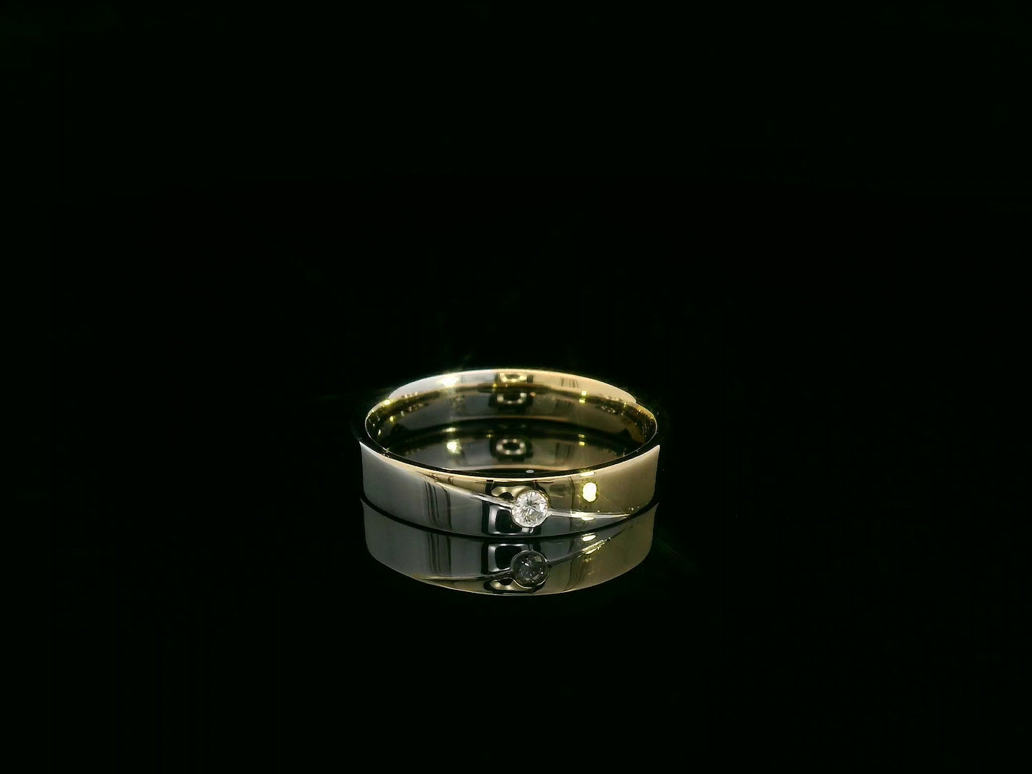 Unisex 18K two-tone wedding band with 0.03 carat bezel-set diamond, sleek modern flat profile