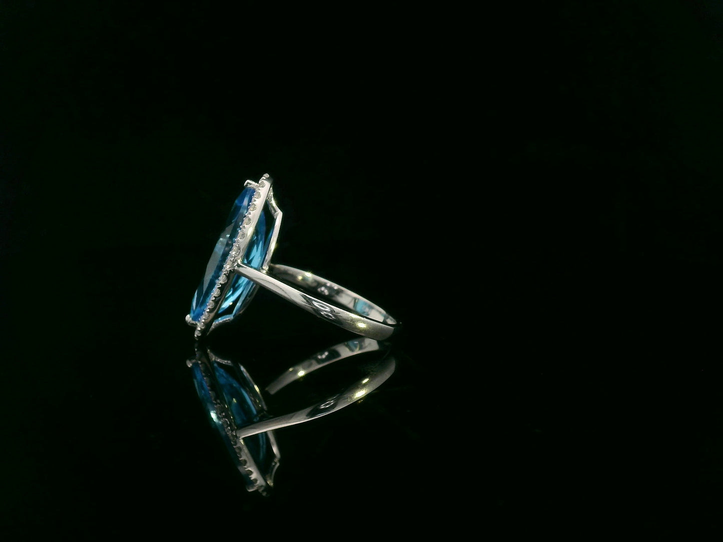 Marquise-cut blue topaz ring with diamond halo in 18K gold
