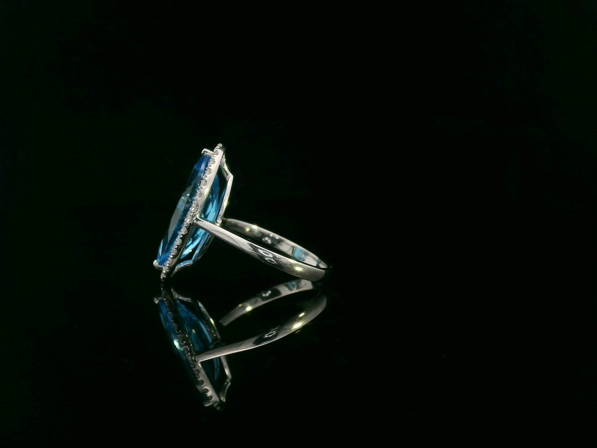 Marquise-cut blue topaz ring with diamond halo in 18K gold