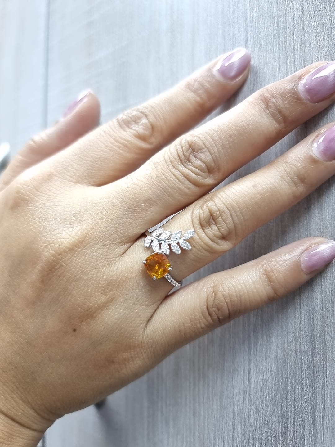 Cushion-cut citrine ring with marquise diamond leaf motif in 18K white gold