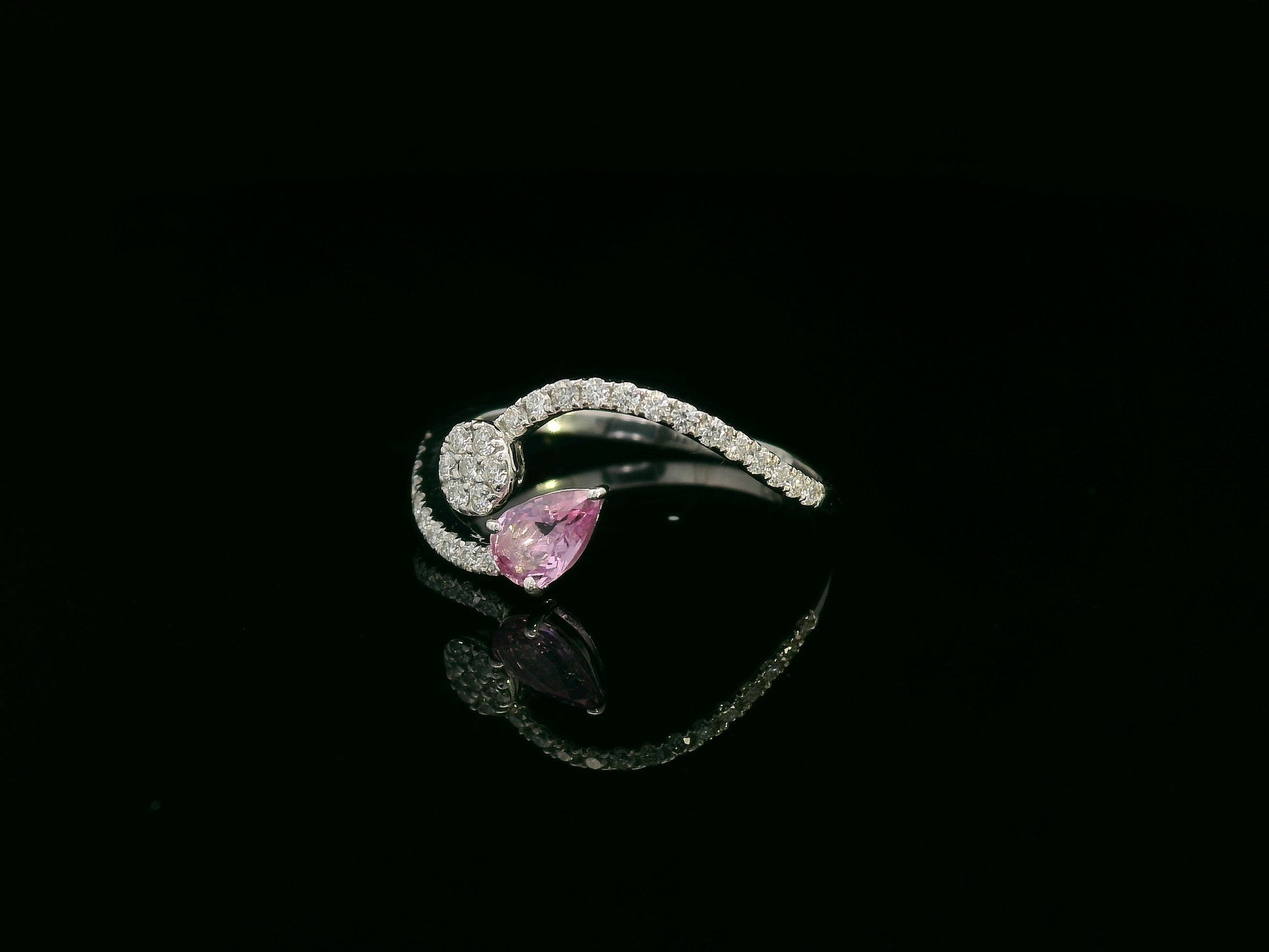 18K white gold bypass ring with pear-cut pink sapphire and diamond cluster