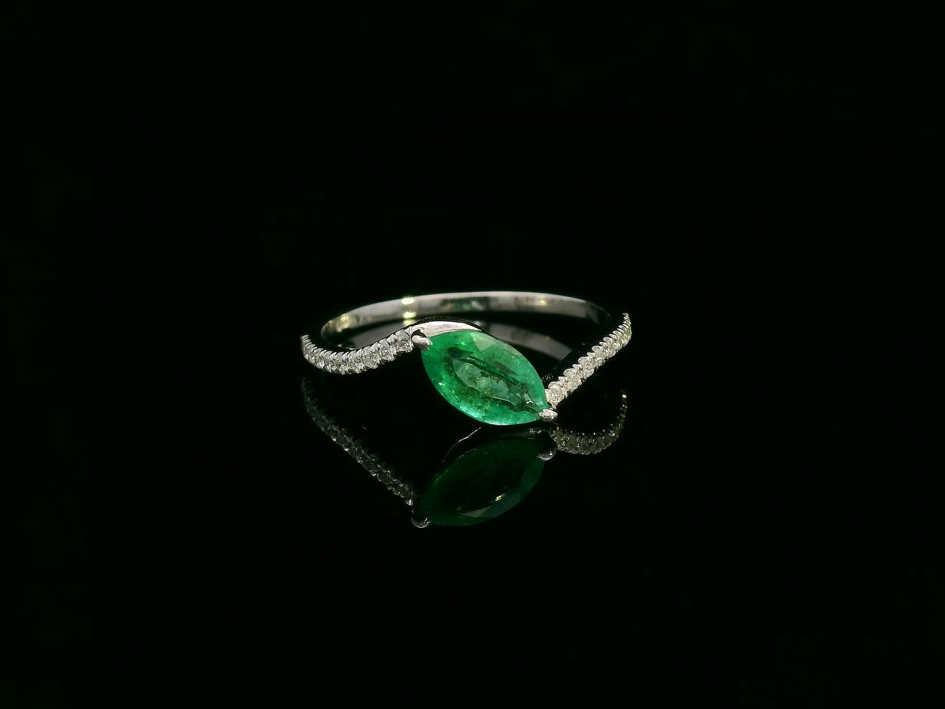 18K white gold emerald and diamond crossover ring with marquise-cut 0.65 carat emerald