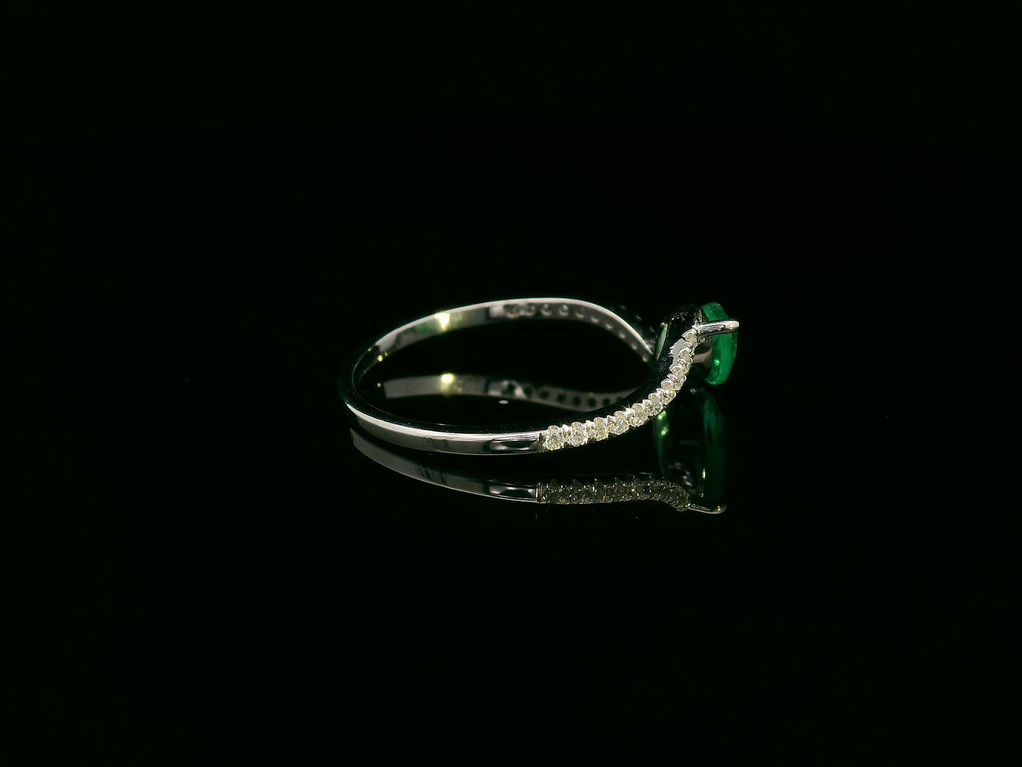 18K white gold emerald and diamond crossover ring with marquise-cut 0.65 carat emerald