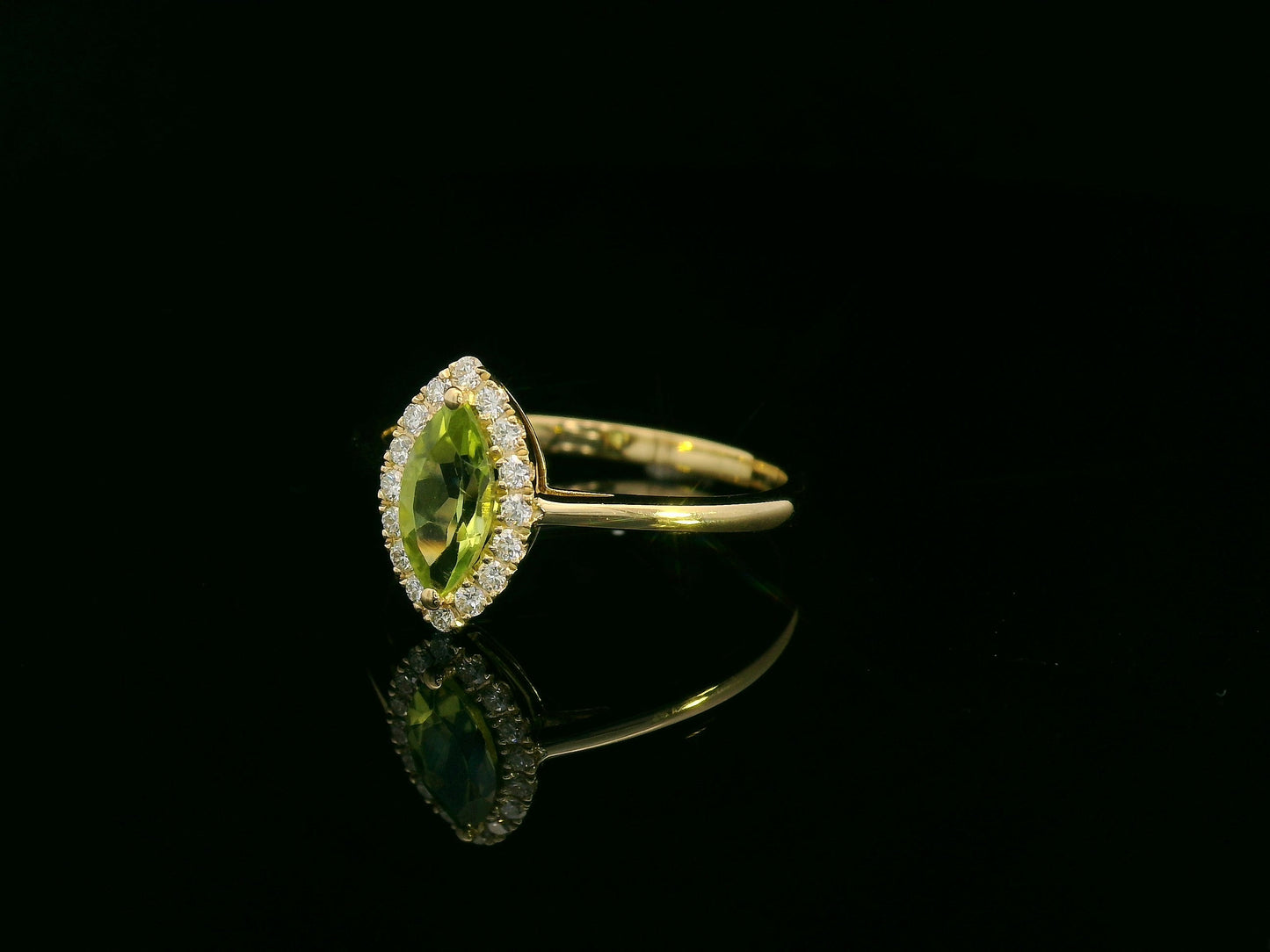 18k yellow gold ring featuring a 0.64ct marquise Peridot surrounded by a 0.15ct diamond halo