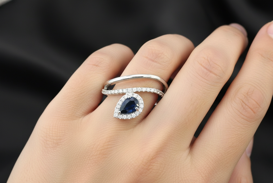 0.61 ct pear-cut blue sapphire and diamond halo ring in 18K white gold with double band design – Emirates Diamonds