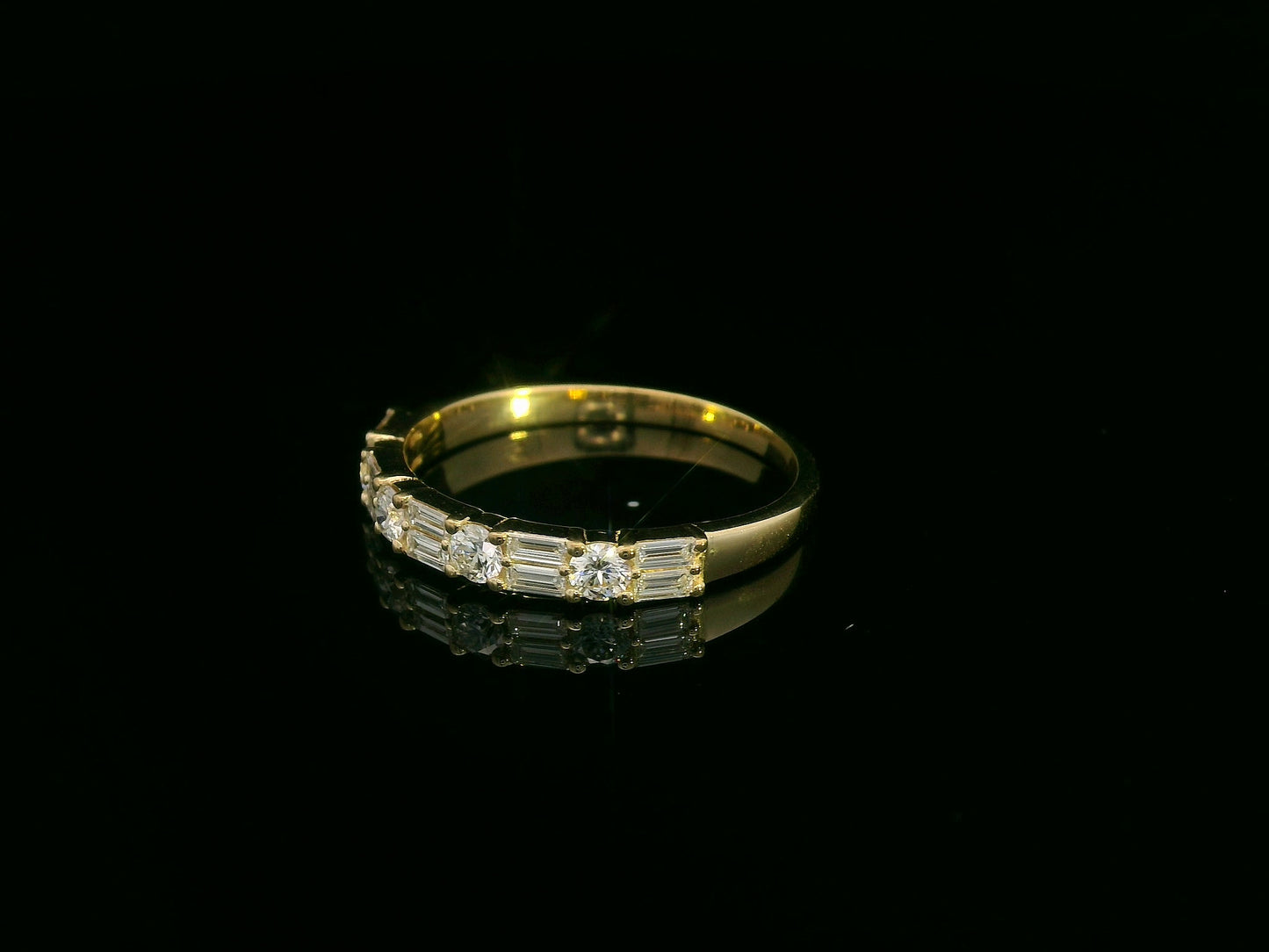 18K yellow gold half eternity diamond band featuring alternating baguette and round-cut diamonds