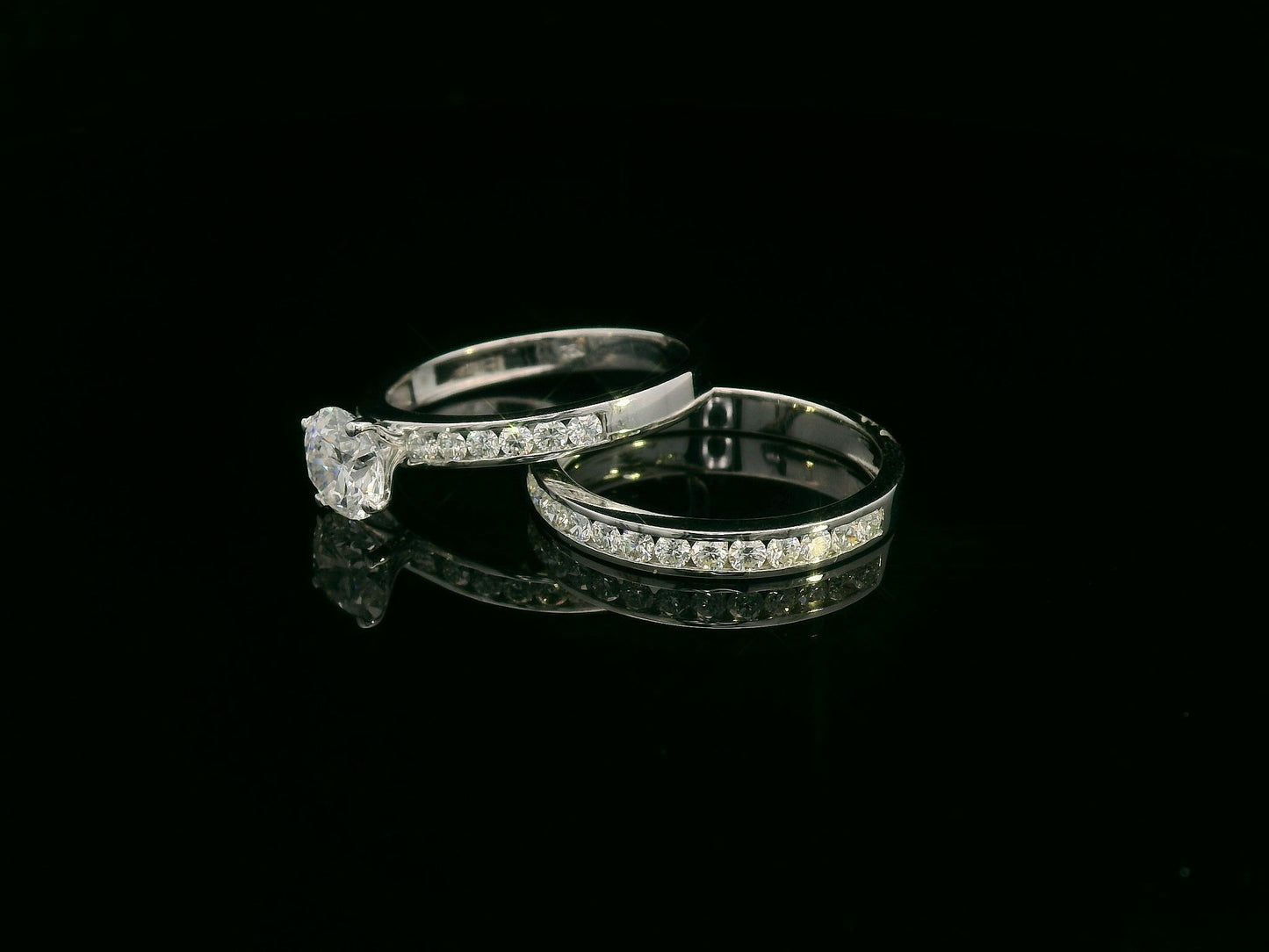 18K white gold diamond bridal set featuring a 1.01 carat GIA certified round diamond with matching diamond engagement ring and wedding band.