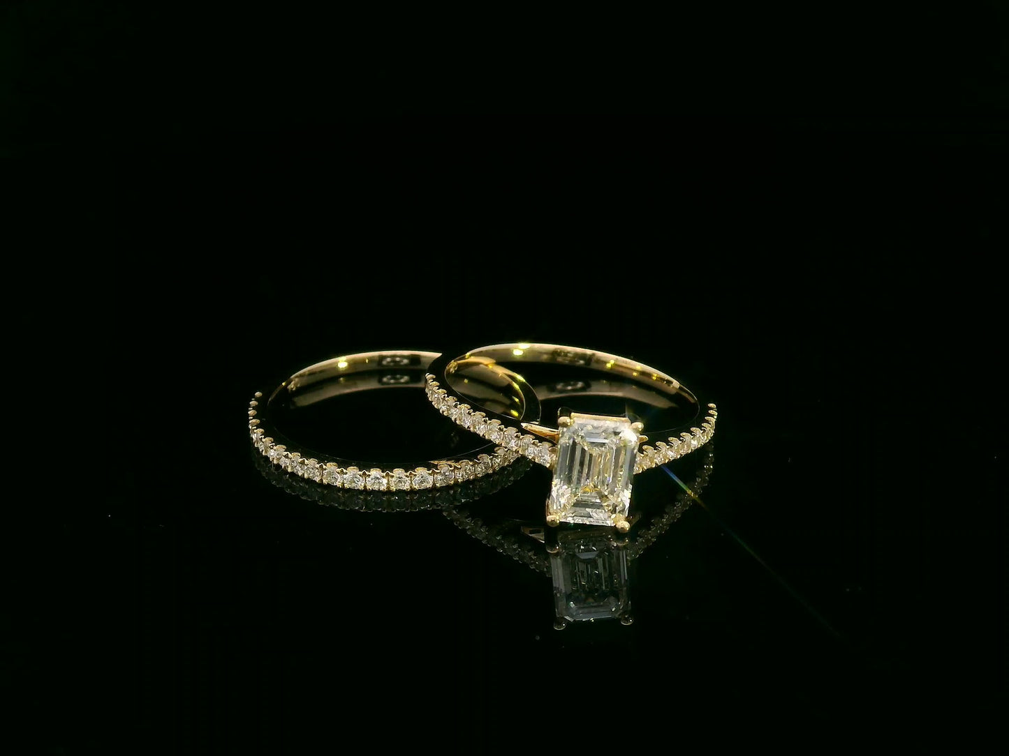 Emerald-cut diamond engagement ring and pavé wedding band bridal set in 18K yellow gold – Emirates Diamonds.