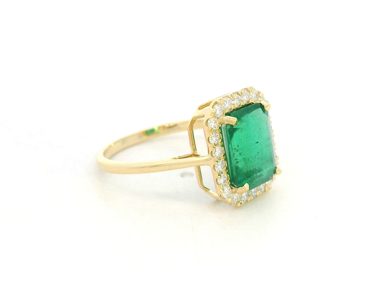 Emerald cut emerald diamond halo ring in 18K yellow gold with natural round diamonds
