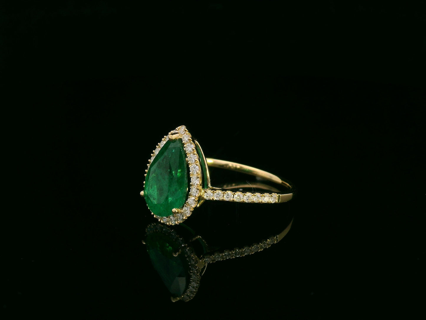18K yellow gold pear-shaped emerald and diamond halo ring with 2.69 carat emerald and 0.40 carat total diamond weight by Emirates Diamonds