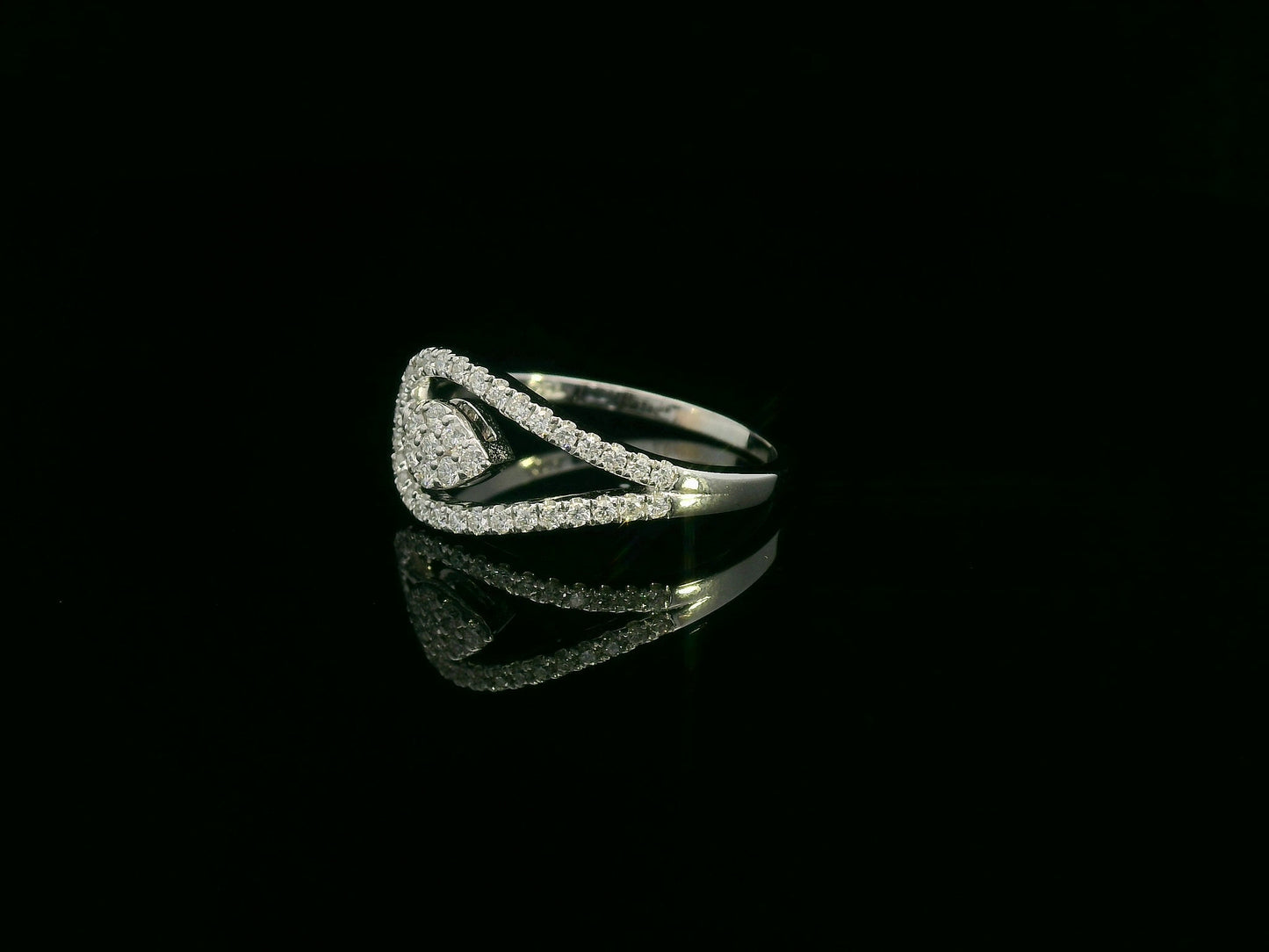 18K white gold diamond bypass ring featuring a teardrop-shaped diamond cluster and pavé set band by Emirates Diamonds
