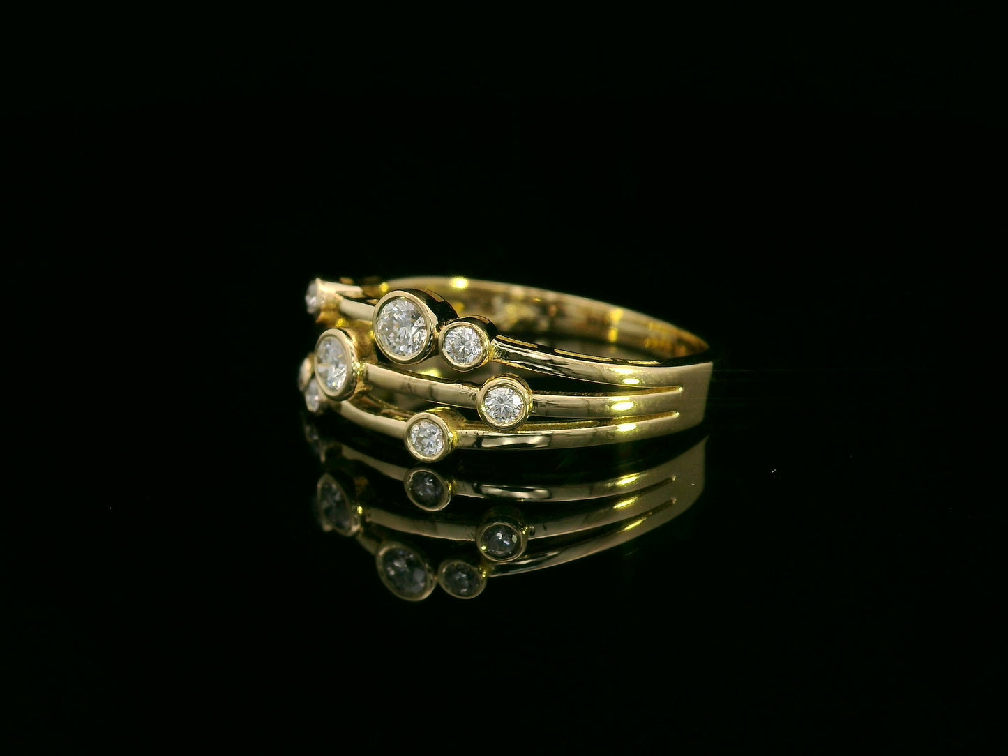 18K yellow gold multi-row diamond ring with bezel-set round diamonds, 0.23 carat diamonds, modern fine jewelry by Emirates Diamonds