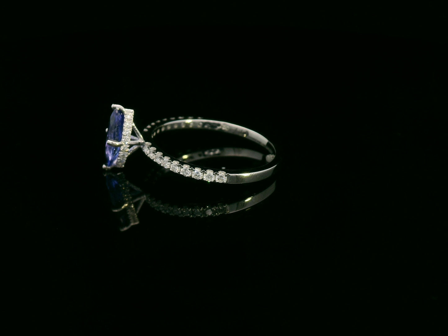 18K white gold marquise-cut tanzanite ring with diamond halo and pavé band by Emirates Diamonds