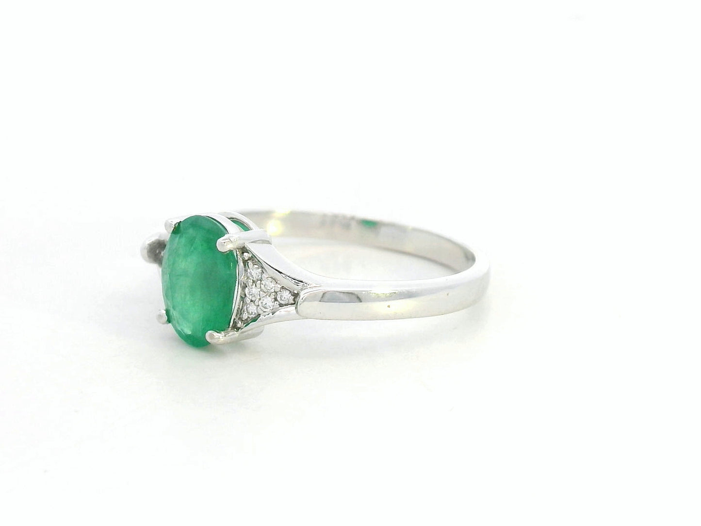 Oval emerald ring in 18K white gold with subtle diamond accents by Emirates Diamonds