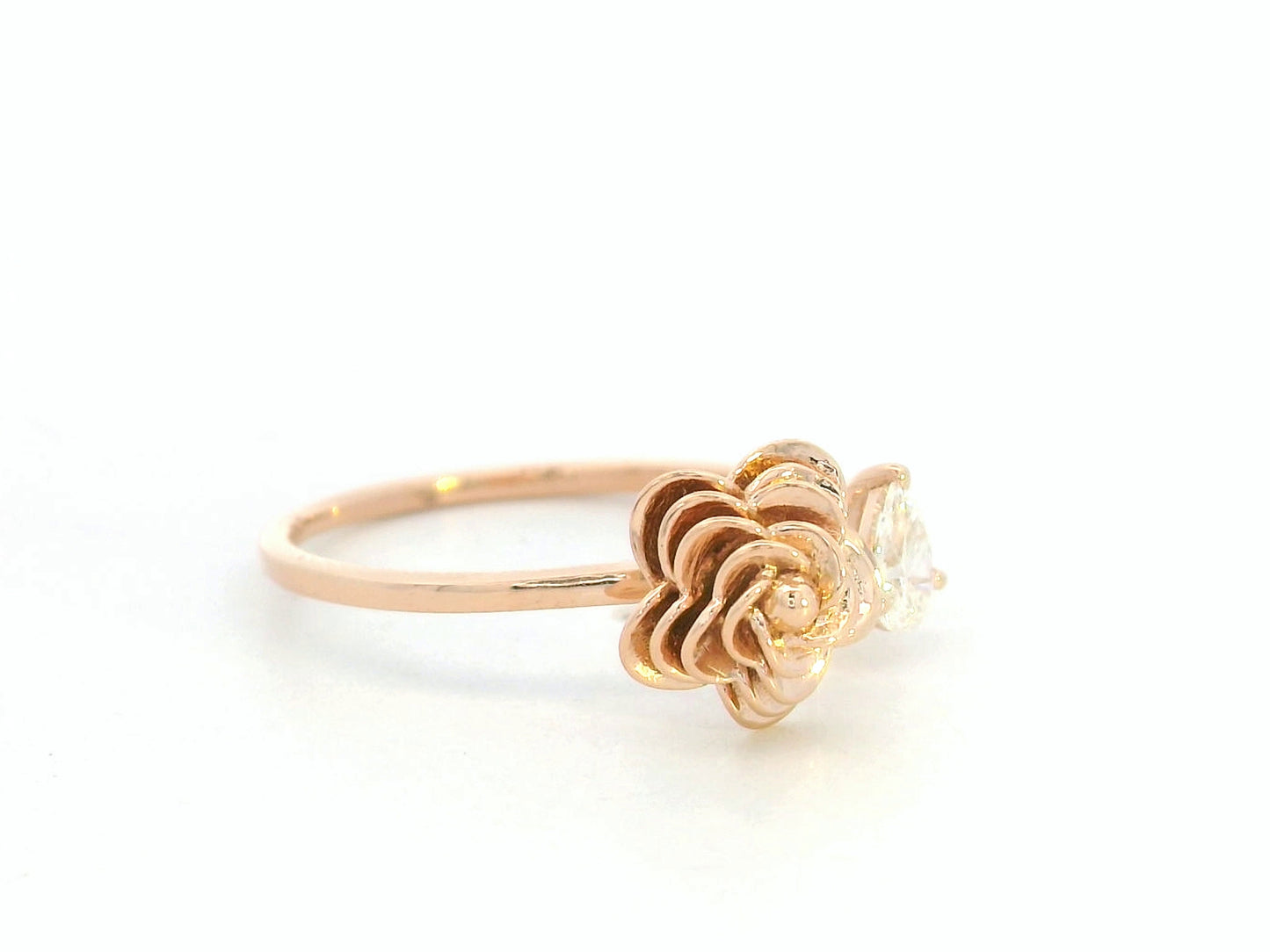 18K rose gold bypass ring featuring a 0.18 carat pear-cut diamond with sculpted floral gold detail – Emirates Diamonds