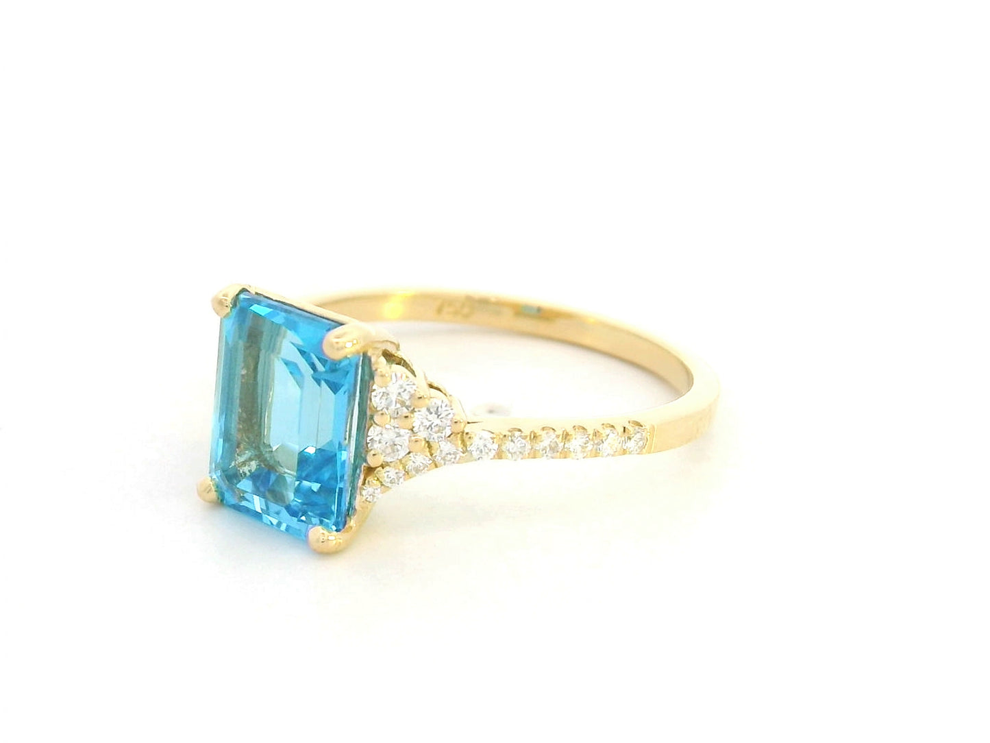 Emerald-cut blue topaz and diamond ring in 18K yellow gold by Emirates Diamonds.