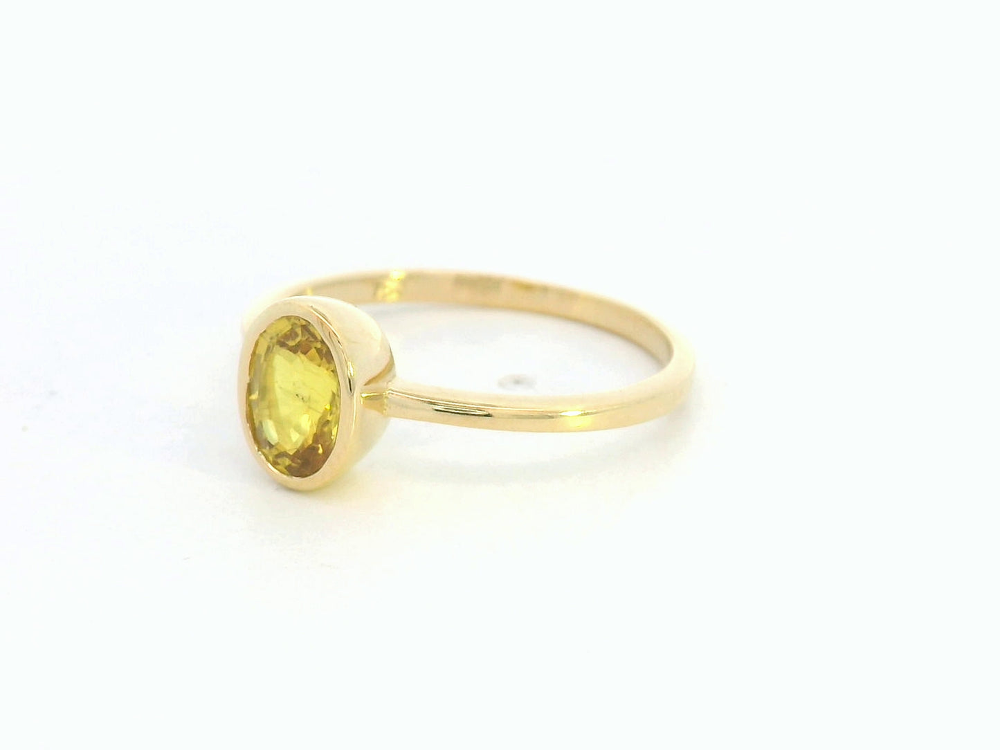 Yellow sapphire solitaire ring in 18K yellow gold featuring a 1.16 carat oval cut gemstone by Emirates Diamonds