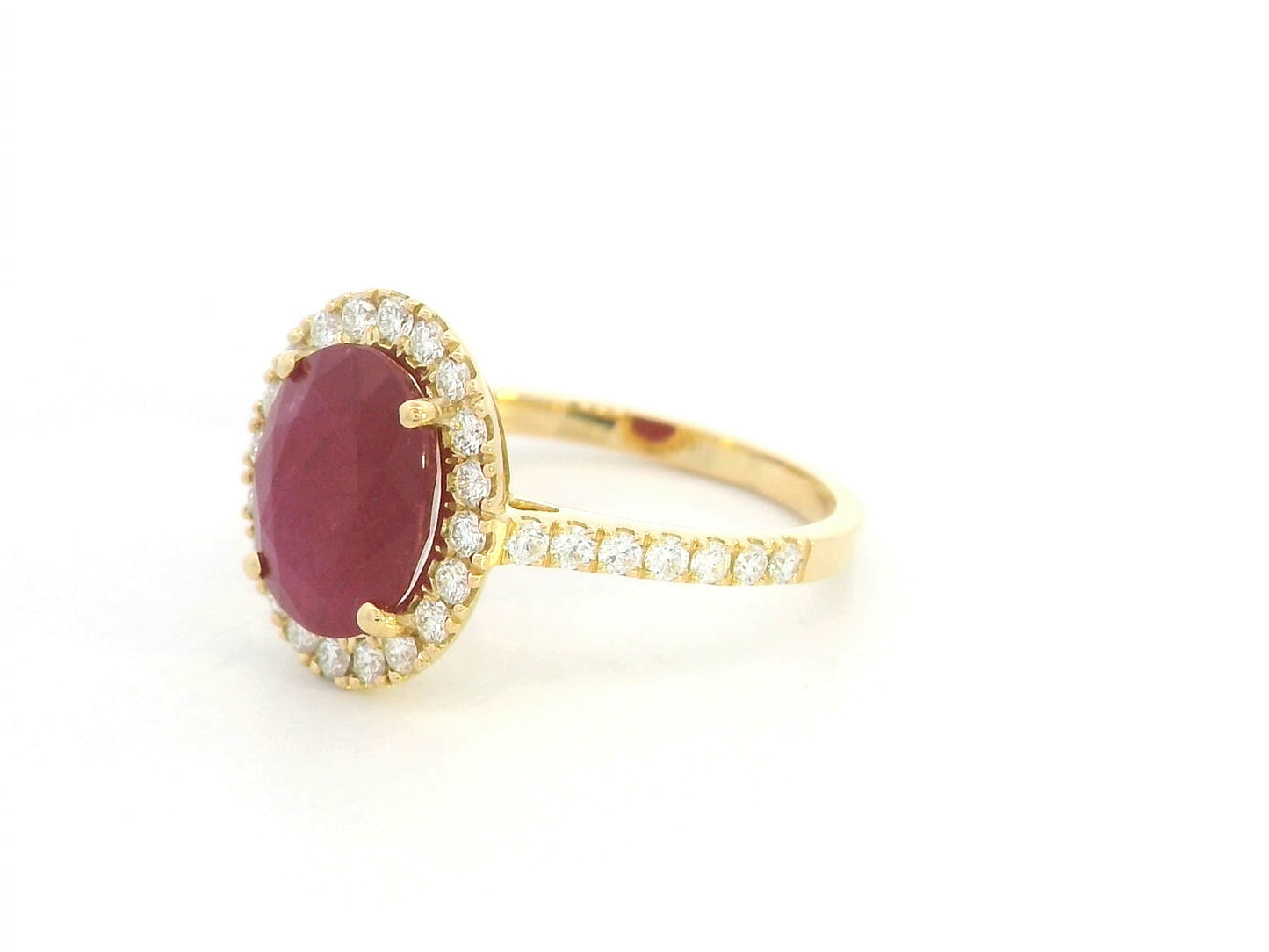 Oval ruby halo ring with diamonds in 18K yellow gold by Emirates Diamonds