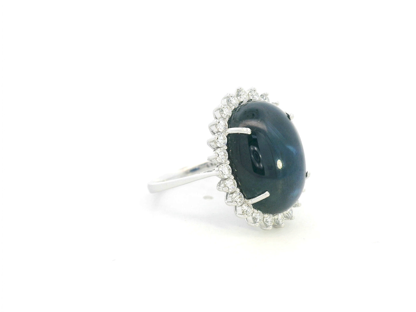 18K white gold oval blue sapphire ring with diamond halo, high-carat sapphire statement ring by Emirates Diamonds