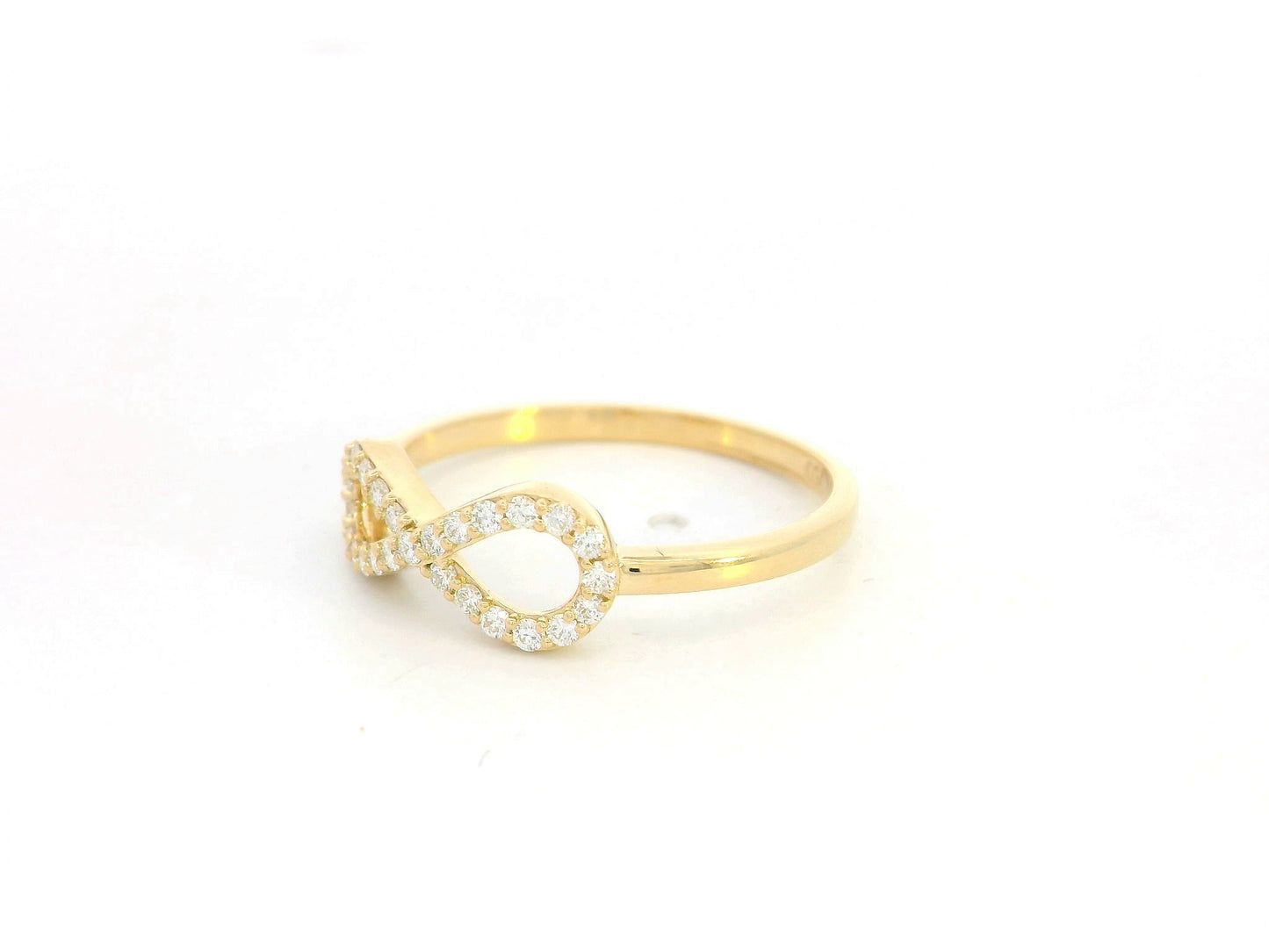 18K yellow gold infinity ring with pavé-set diamonds, total diamond weight 0.21 carat, Emirates Diamonds.