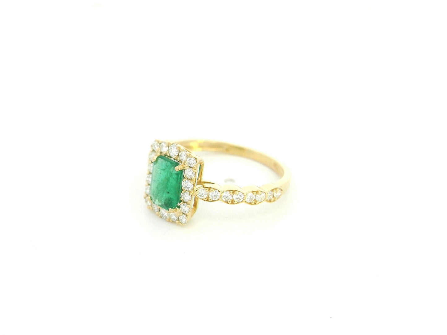 Emerald diamond halo ring in 18K yellow gold with emerald cut center and diamond band