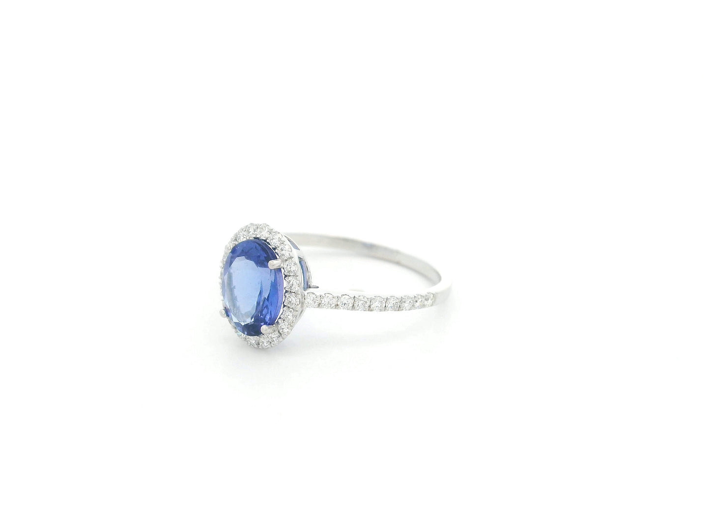 Tanzanite and diamond halo ring in 18K white gold oval gemstone design